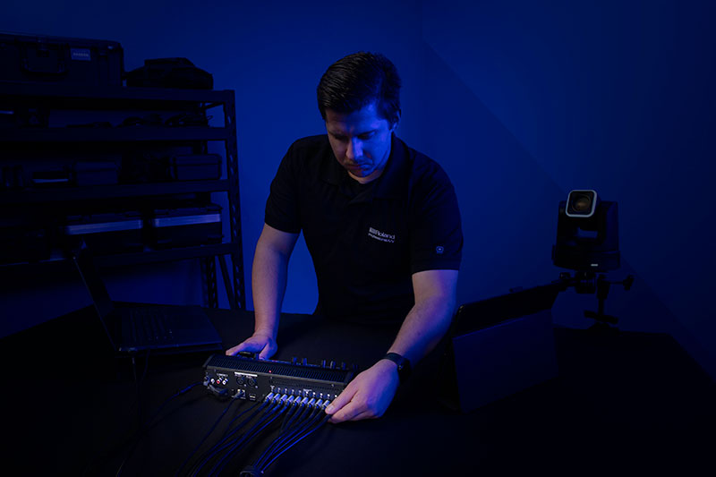 Technician with Roland's V-1-4K Video Switcher