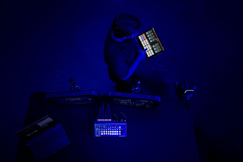 Technician with Roland V-1-4K Switcher and V-1-4K Remote app