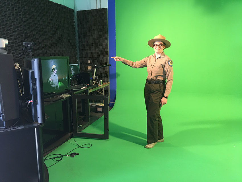 California Parks interpretive ranger on the green-screen set guiding a virtual field trip.